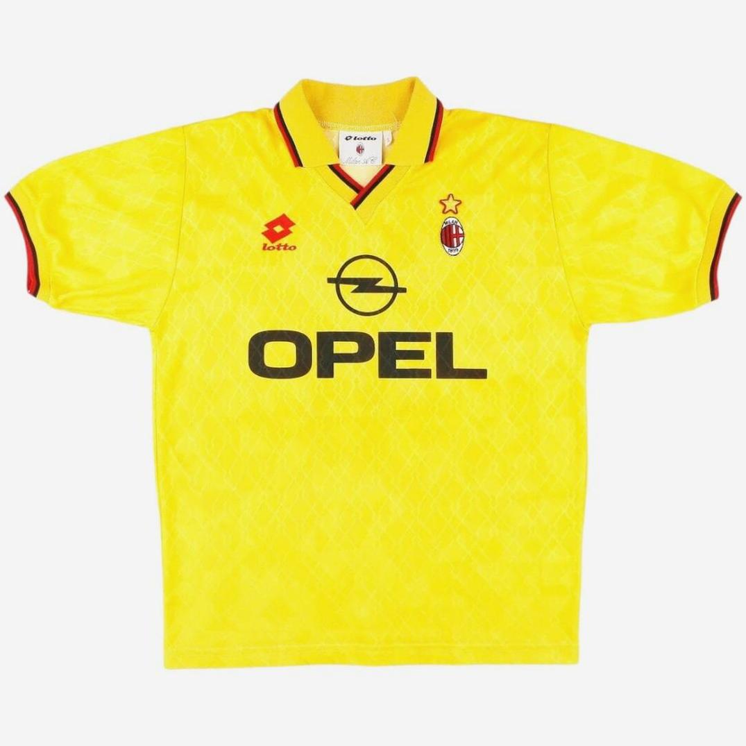 The Retro1999 AC Milan 1995-96 Third Shirt is a yellow football jersey with red and black trim, featuring the Lotto logo, Opel sponsor, and a club crest with a star—an authentic retro kit shown on a white background.
