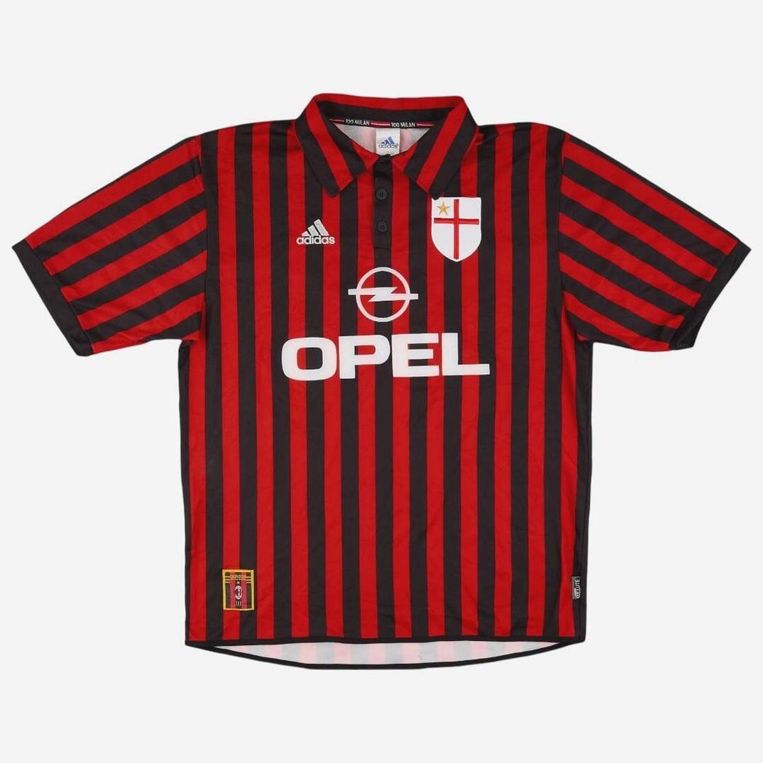 The AC Milan 1999-00 Centenary Home Shirt by Retro1999 features red and black stripes, white collar and cuffs, Adidas logo, Opel sponsor, and a crest with red cross and yellow star—perfect for celebrating football heritage.