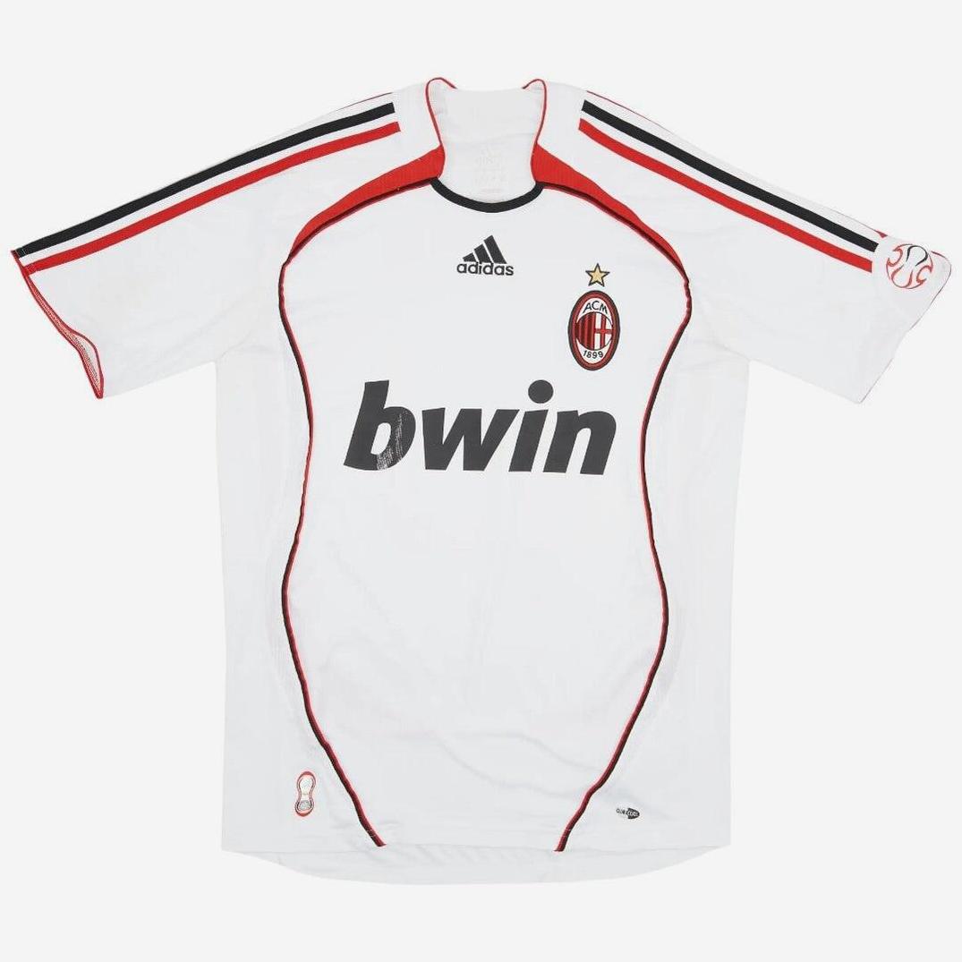 The AC Milan 2006-07 Away Shirt by Retro1999 features red and black trim, classic club crest with single star, bwin sponsor, Adidas logo, and black shoulder stripes—the ideal retro kit for true football fans.