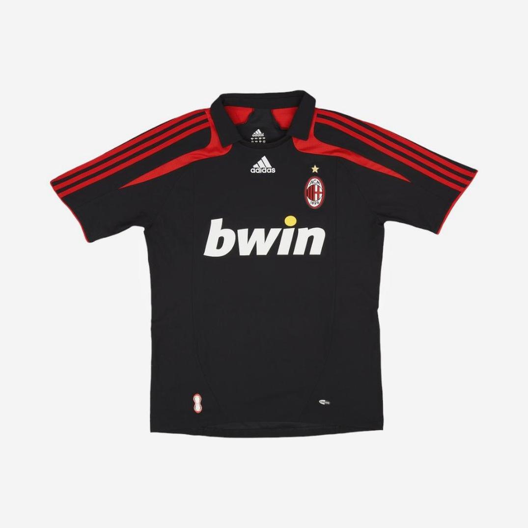 A black and red Retro1999 AC Milan 2007-08 Third Shirt featuring a “bwin” sponsor, AC Milan crest with gold star, three red shoulder stripes, and quality material is displayed on a plain white background.