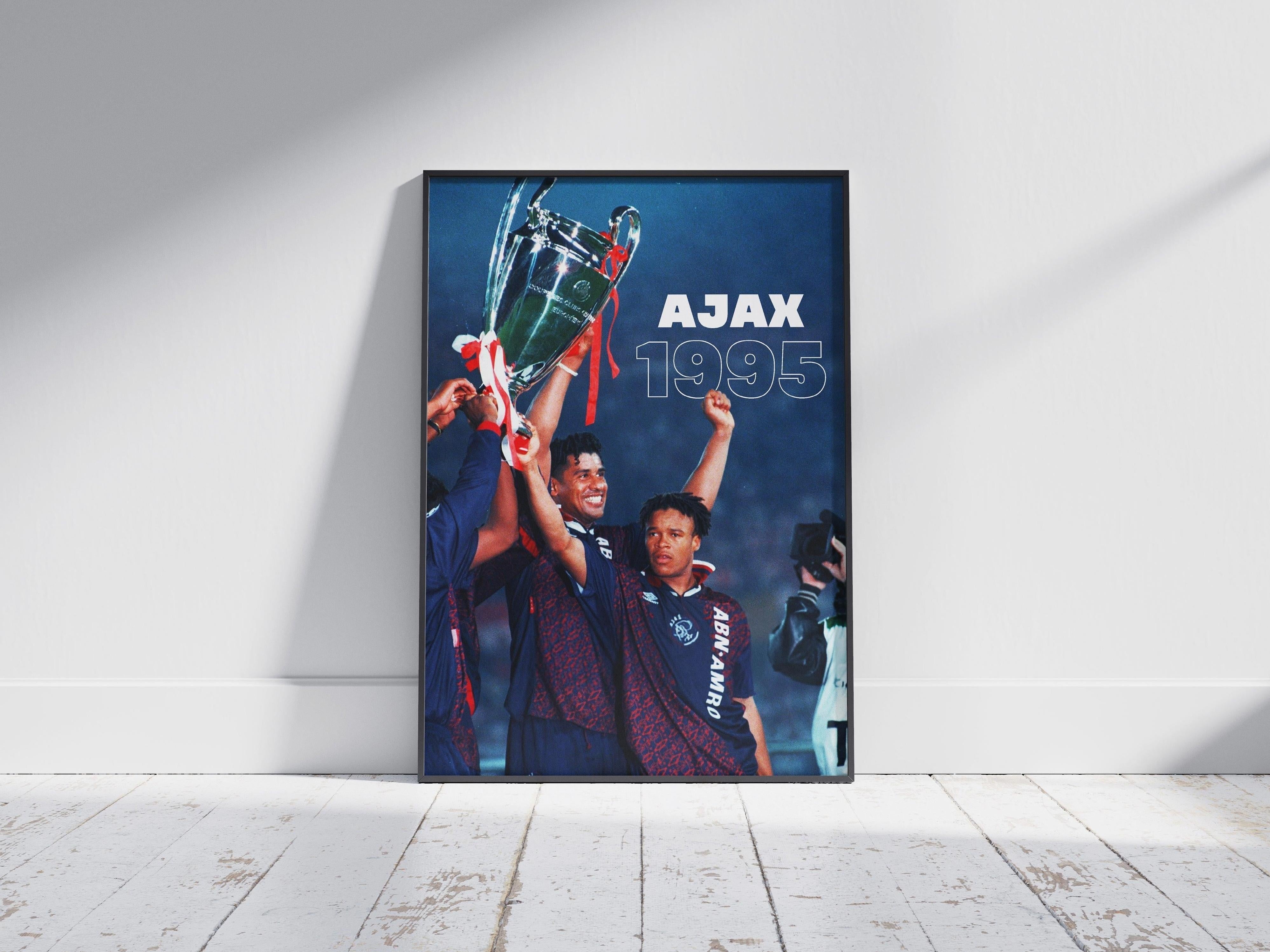 The Ajax 1995 Champions League Poster by Retro1999 features two Ajax players celebrating with the trophy, AJAX 1995 beside them—a must-have football memorabilia for fans, perfect for display on any wall.
