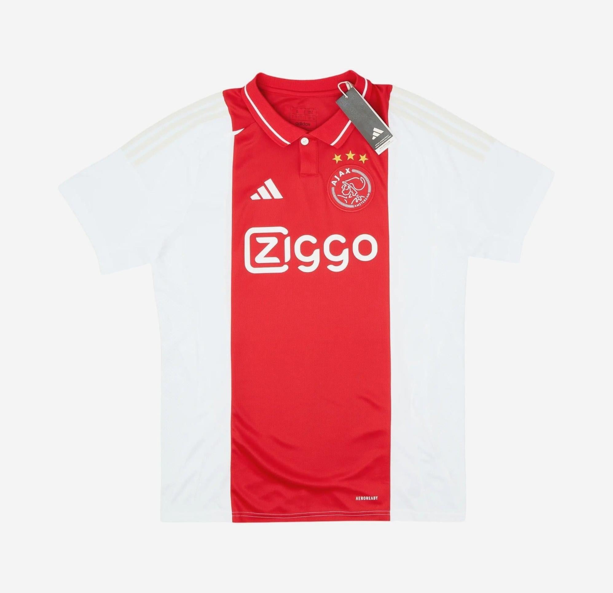 The Ajax 2024-25 Home Shirt by Retro1999 features a red and white design, Ziggo sponsor, Adidas details, three stars above the crest, and a classic collar. Made from premium fabric with tags attached.