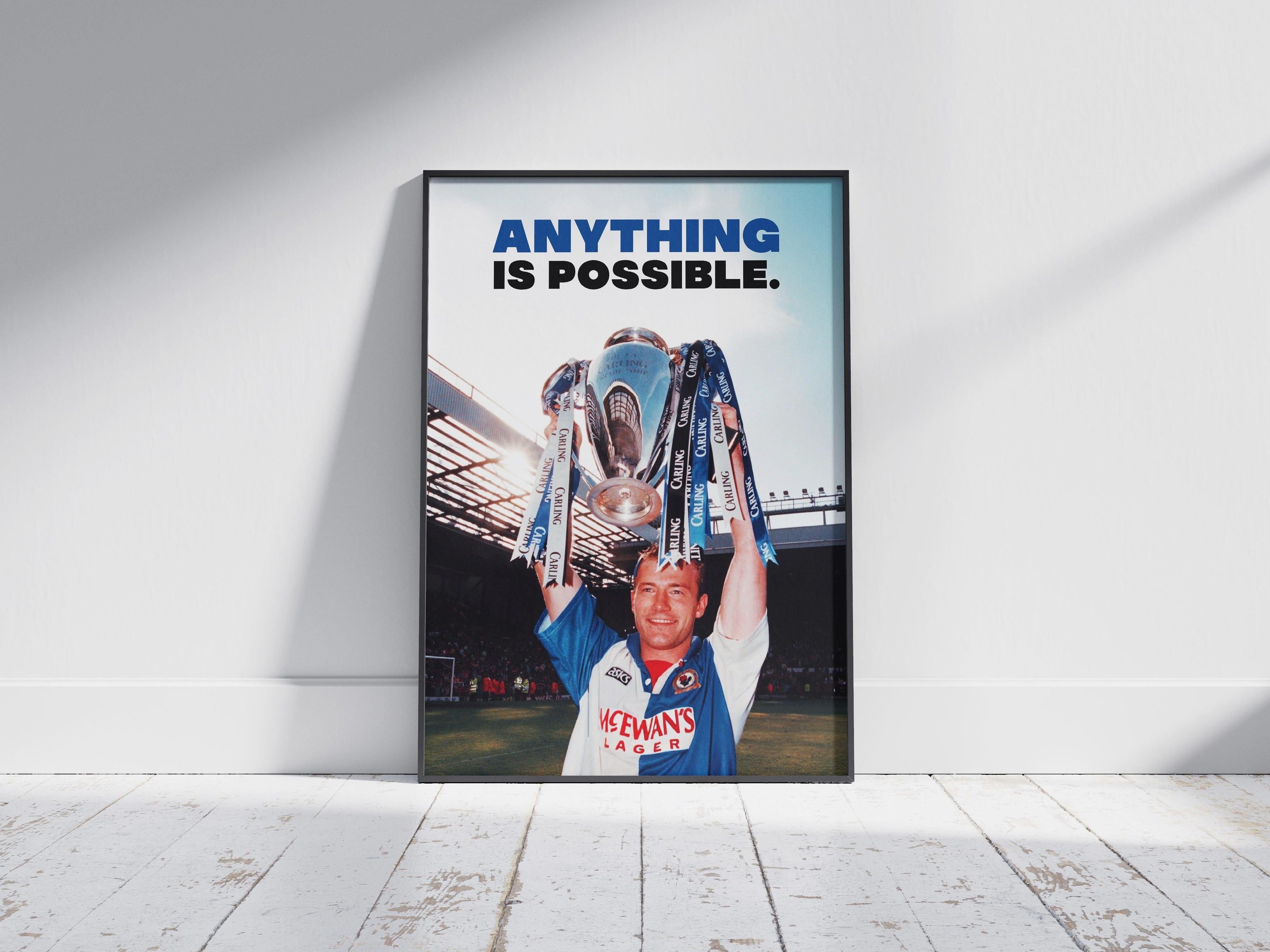 The Retro1999 Alan Shearer Anything Is Possible Poster features a photo of Shearer in a blue and white Blackburn Rovers jersey lifting the FA Carling Premiership trophy, with ANYTHING IS POSSIBLE. boldly printed at the top.