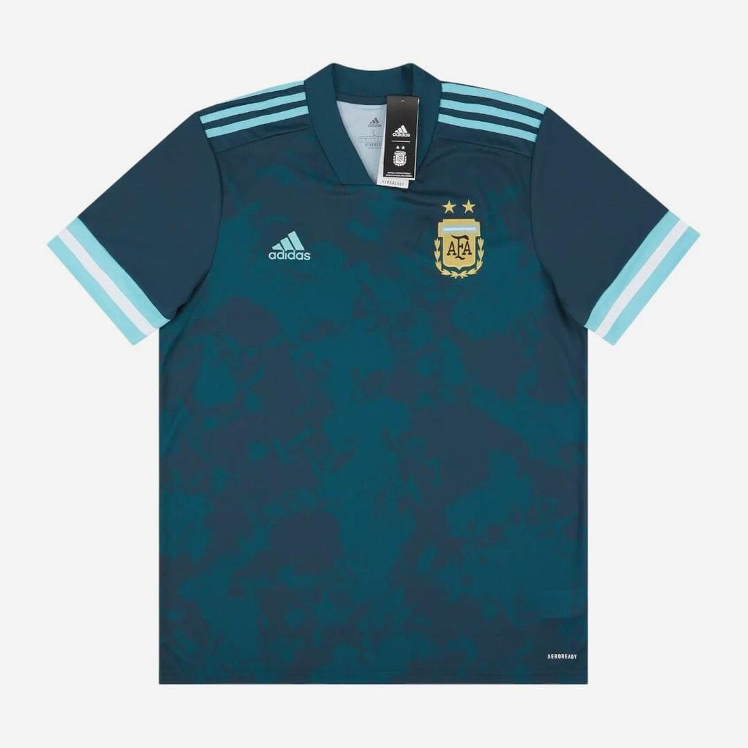 The Retro1999 Argentina 2020-22 Away Shirt features a dark teal color, light blue shoulder stripes, and two stars on the crest—delivering a retro kit vibe. Tags are attached at the collar.