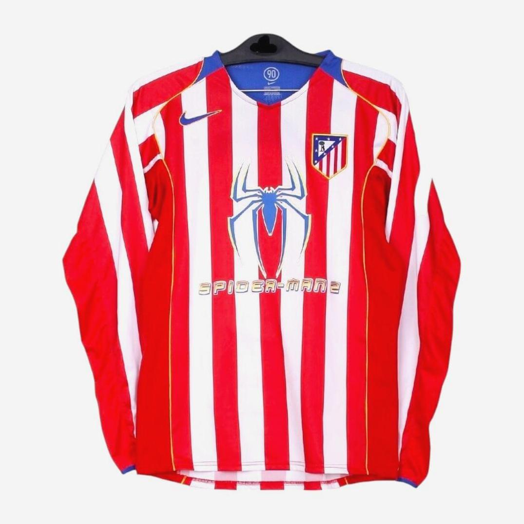 The Retro1999 Atletico Madrid 2004-05 Home Shirt Longsleeve features red and white stripes, a blue Nike logo, Atlético Madrid crest, and a large blue Spider-Man logo with SPIDER-MAN 2 below it on the front, shown hanging on a hanger.