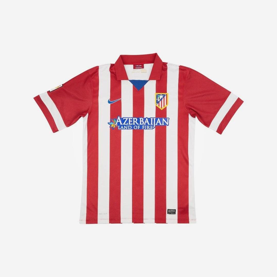 The Retro1999 Atletico Madrid 2013-14 Home Shirt features red and white vertical stripes, short sleeves, club badge, Nike logo, and Azerbaijan Land of Fire sponsor on the front—made for comfort and durability.
