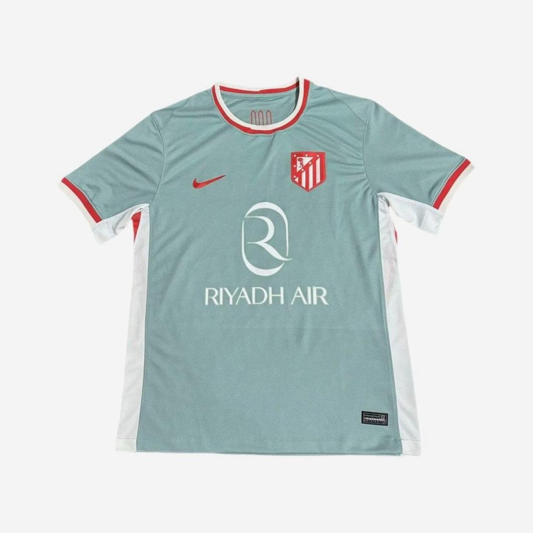 Show your La Liga pride with the Atletico Madrid 2024-25 Away Shirt by Retro1999. This light teal kit features red and white trim, a retro vibe, red Nike logo, club crest, Riyadh Air sponsor, white side panels, and a standout red collar.