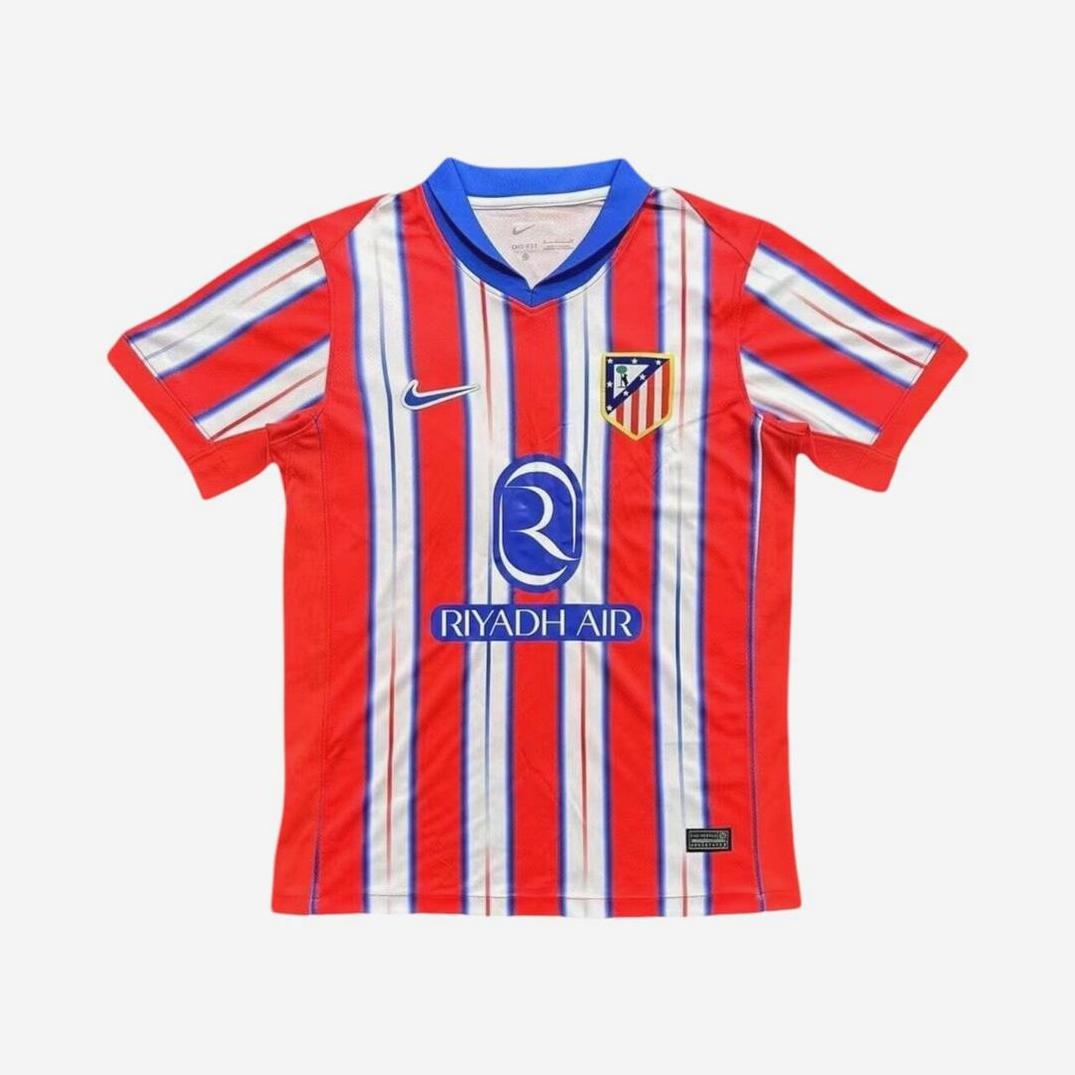 The Retro1999 Atletico Madrid 2024-25 Home Shirt features red and white stripes, a blue collar, club crest, Nike logo, and Riyadh Air sponsor—ideal for La Liga fans. Displayed on a white background.