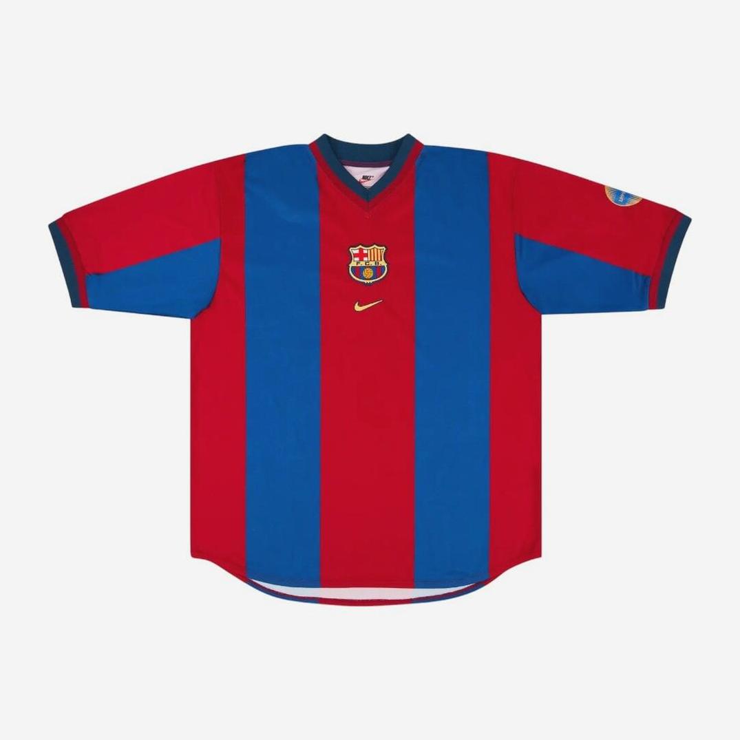 The Retro1999 Barcelona 1998-99 Home Shirt features red and blue stripes, short sleeves, club crest on the left chest, Nike logo right chest, and a left sleeve patch, displayed against a plain white background in nostalgic style.