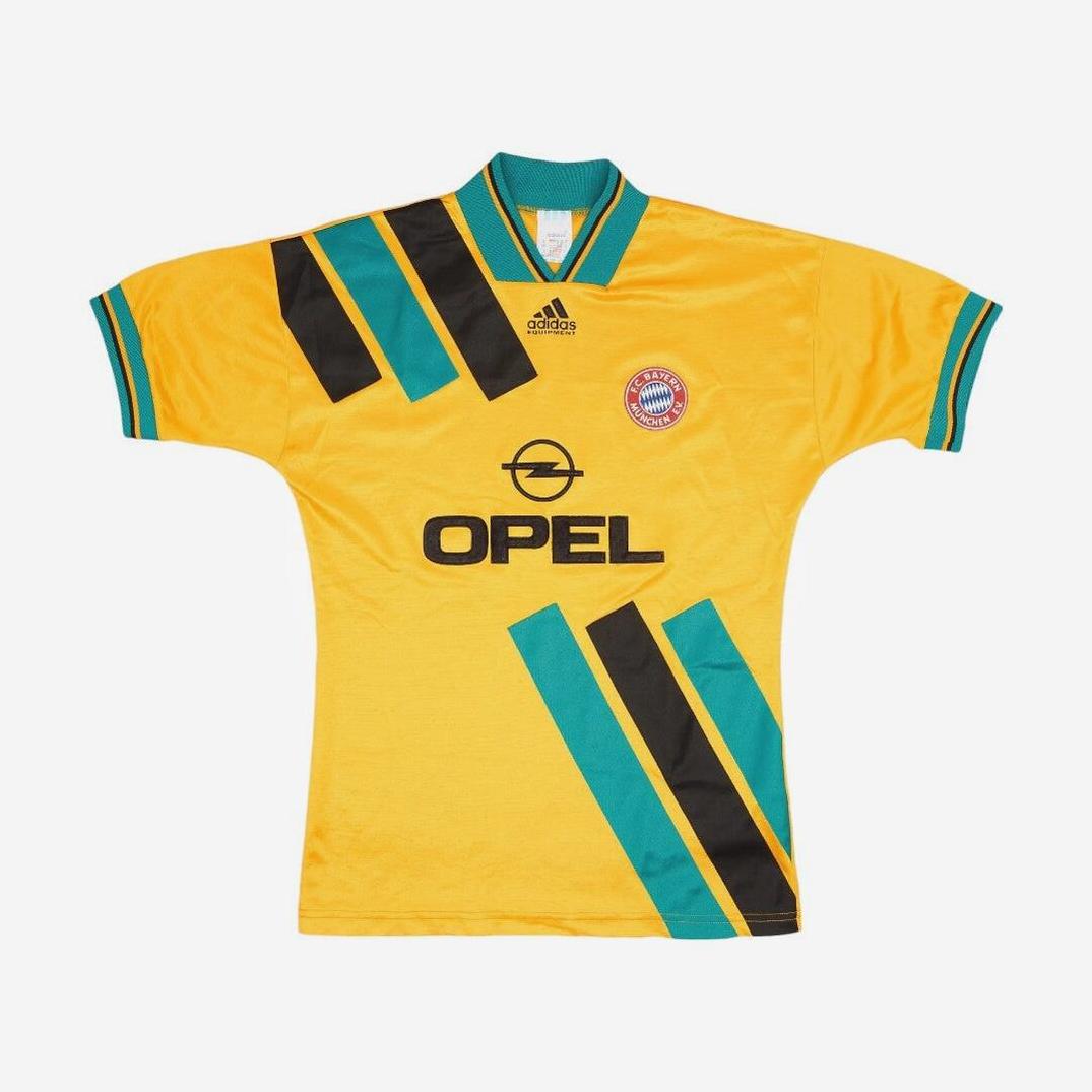 The Retro1999 Bayern Munich 1993-94 Away Shirt features a yellow base with green and black diagonal stripes, signature Adidas logo, Opel sponsor, club crest, and classic Bundesliga-style collar and sleeve trim.