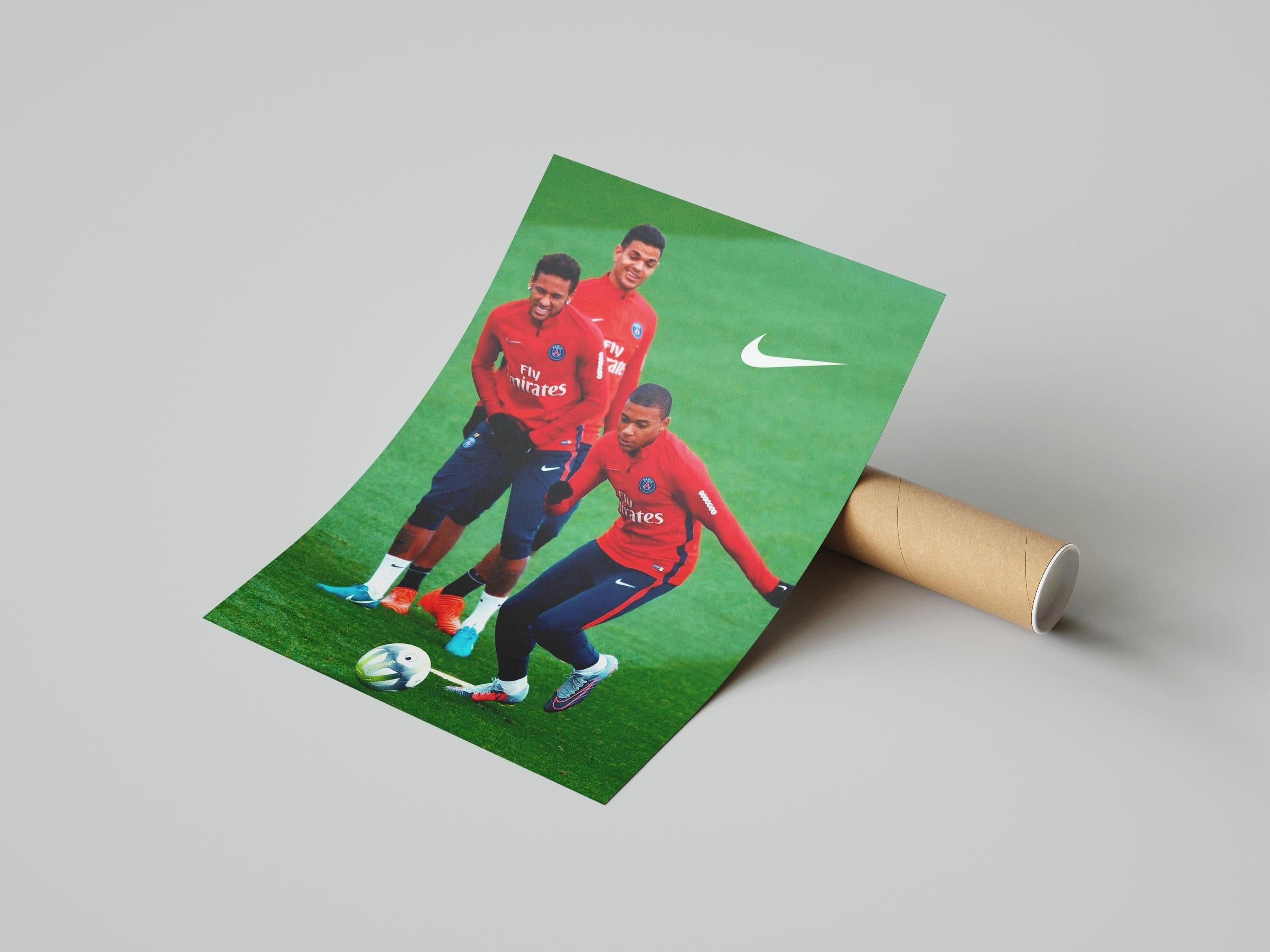 The Retro1999 Ben Arfa x Neymar x Mbappe Poster shows Neymar, Mbappe, and Ben Arfa in red Nike jerseys on a green field. Neymar dribbles the ball while Ben Arfa and Mbappe stand behind smiling. Rolled poster format.