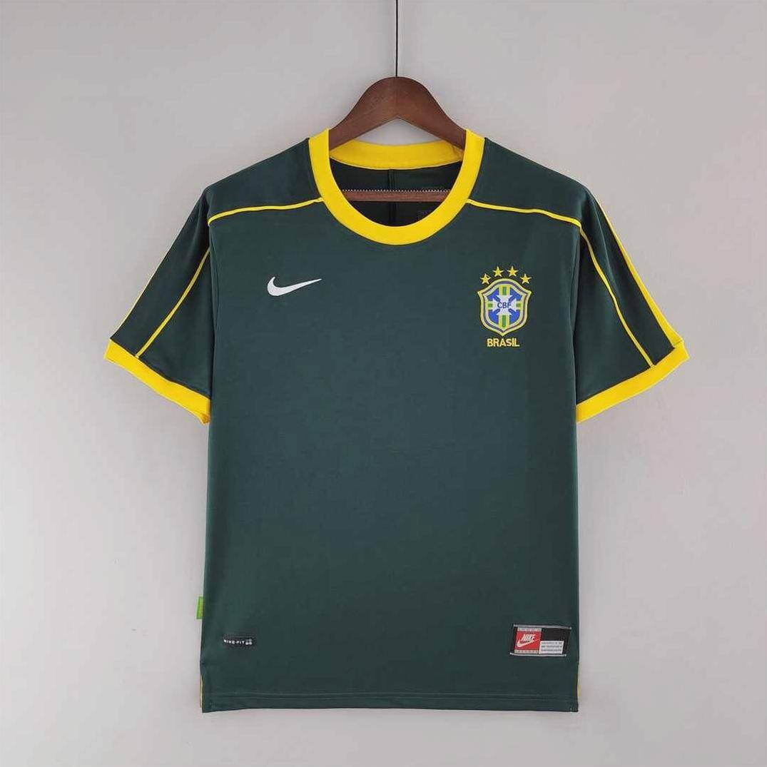 The Brazil 1998 Goalkeeper Shirt by Retro1999 features dark green fabric with yellow collar and sleeve trim, Nike logo, and a five-star Brazil crest—a classic retro kit perfect for any Brazilian football fan.