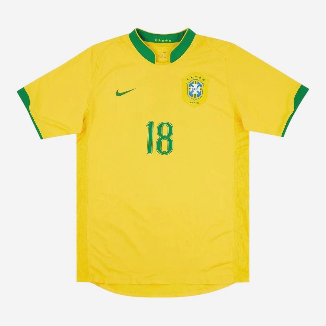 The Retro1999 Brazil 2006 Home Shirt features yellow fabric with green trim, number 18 in green, a Nike logo, and the Brazil crest—ideal for fans of the iconic retro Brazilian national team kit.