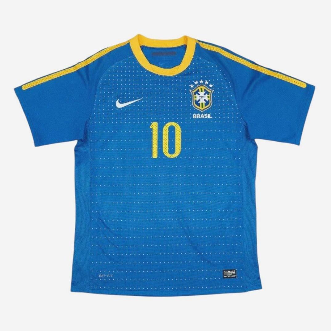 The Brazil 2010 Away Shirt by Retro1999 features yellow accents, the iconic number 10, and classic chest logos—an essential item for any retro football kit collection.