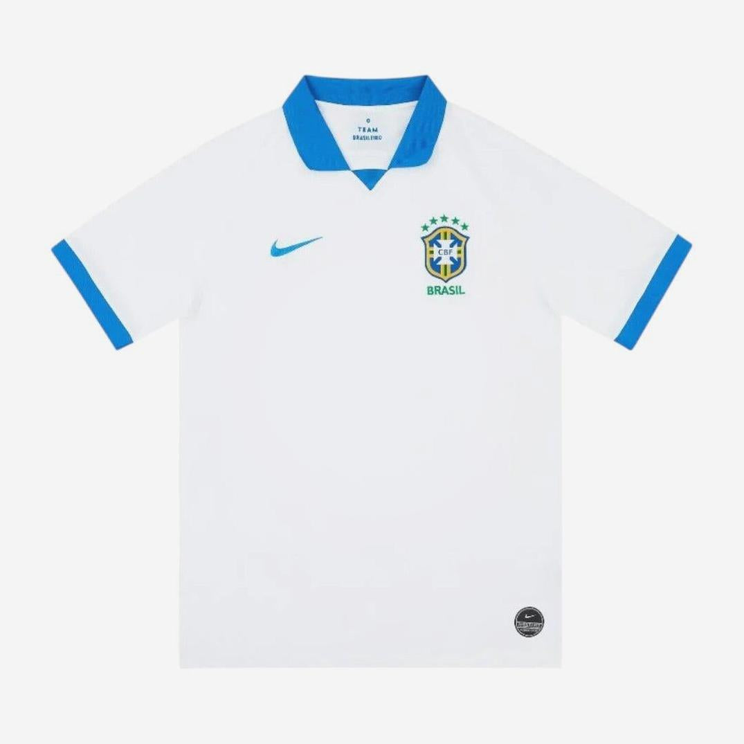 The Brazil 2019 Away Shirt by Retro1999 is a white jersey with blue collar and sleeve trim, retro-inspired, featuring the Brazil crest with five stars and a green Nike logo on the chest.