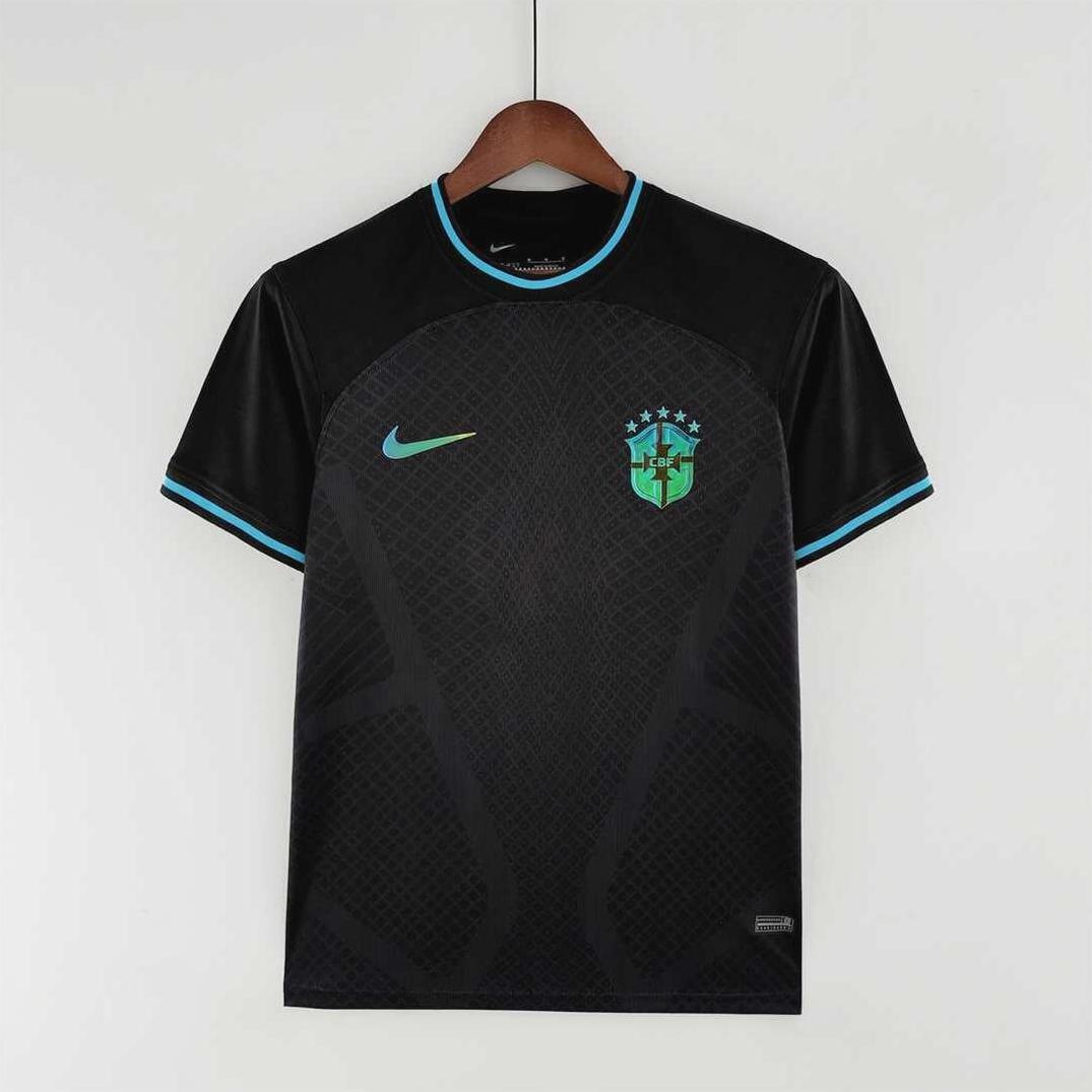 The Retro1999 Brazil 2022 Concept Shirt Special is a black short-sleeve soccer jersey with blue accents, a turquoise Nike logo, and a green Brazil crest with five stars on the chest, shown on a wooden hanger against a white background.