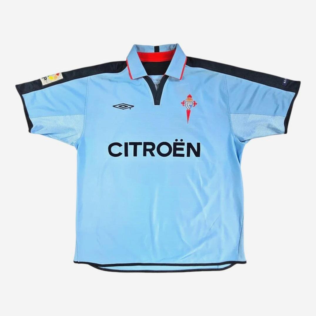 The Celta Vigo 2003-05 Home Shirt by Retro1999 features light blue colors, black and red accents, CITROËN across the front, an Umbro logo on the right chest, and the club crest on the left—a must-have for classic La Liga fans.