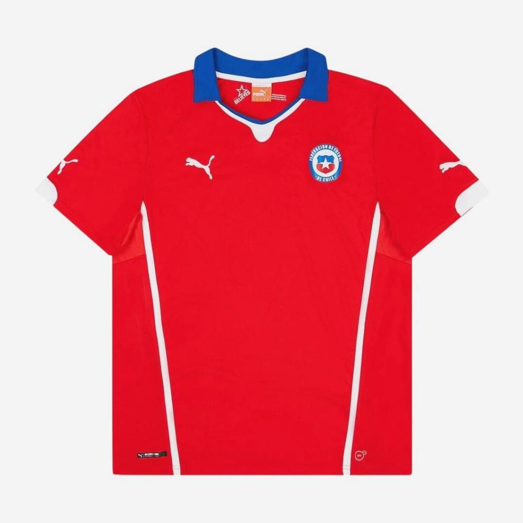 The Retro1999 Chile 2014 Home Shirt features a red design with white accents, blue collar, Puma logos on chest and sleeves, and the Chile national team badge on the left chest. Displayed flat on a white background.