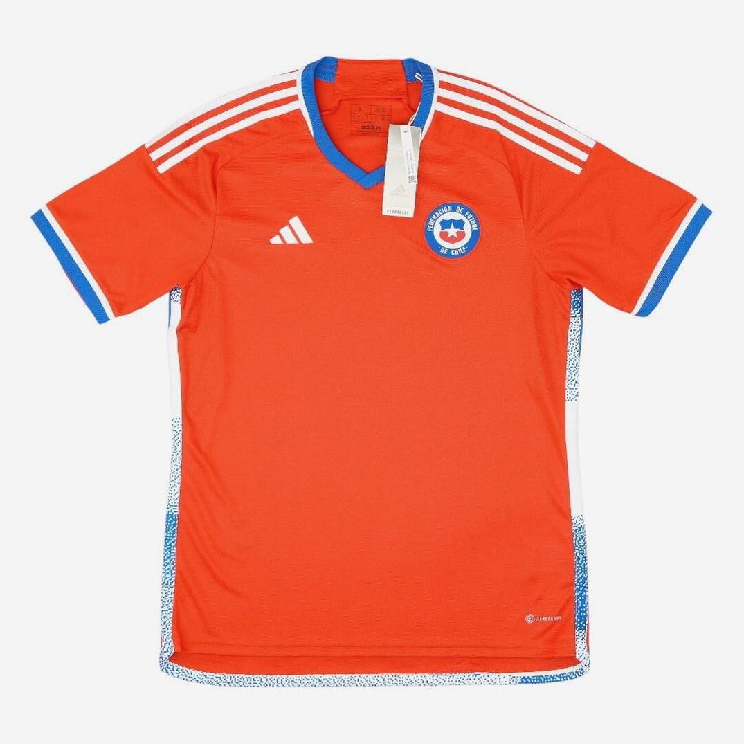 The Retro1999 Chile 2022 Home Shirt is an orange soccer jersey with white shoulder stripes, blue accents, and a star-crested Federación de Fútbol de Chile badge—ideal for collectors and national team fans.