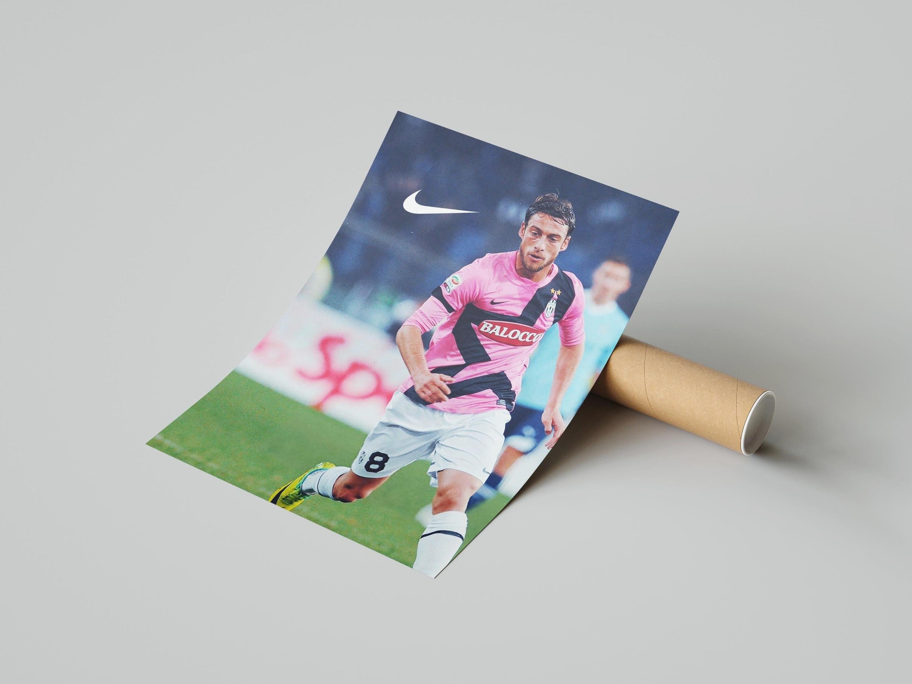 The Claudio Marchisio x Juventus 2011/12 Poster by Retro1999 shows Marchisio in a pink and black striped jersey running on the field with a white Nike logo—ideal Serie A memorabilia for fans.