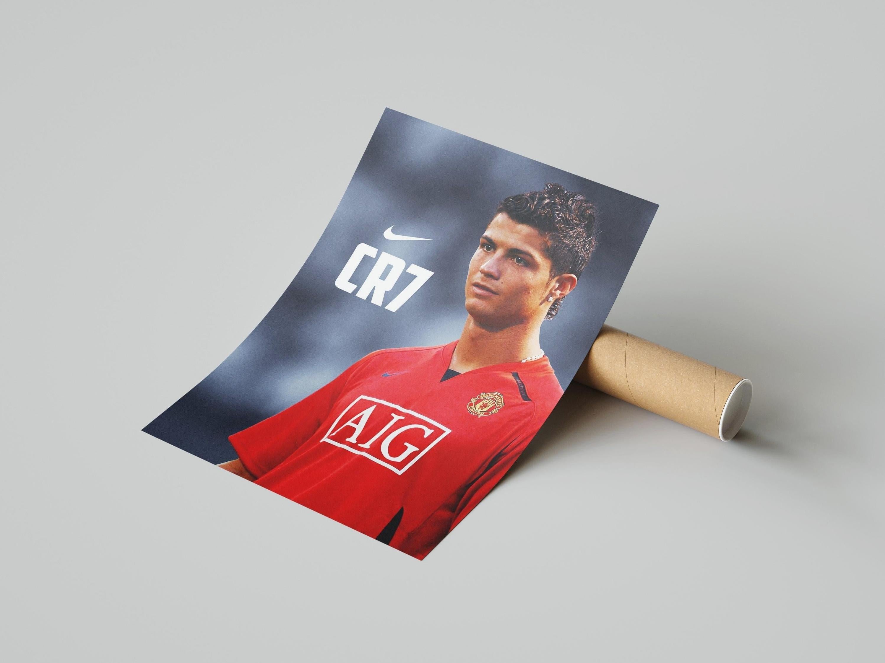 The CR7 Manchester United Poster by Retro1999 features Cristiano Ronaldo in a red kit with AIG and Nike logos—an essential piece of football memorabilia for any fan.