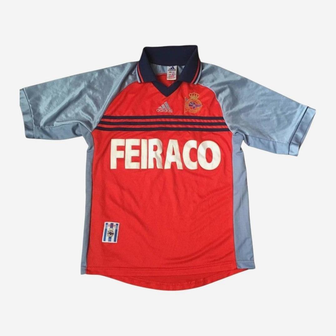 The Retro1999 Deportivo 1999-00 Third Shirt is a red and light blue retro soccer jersey with bold white FEIRACO, Adidas logo, and club crest—ideal for classic La Liga fans.