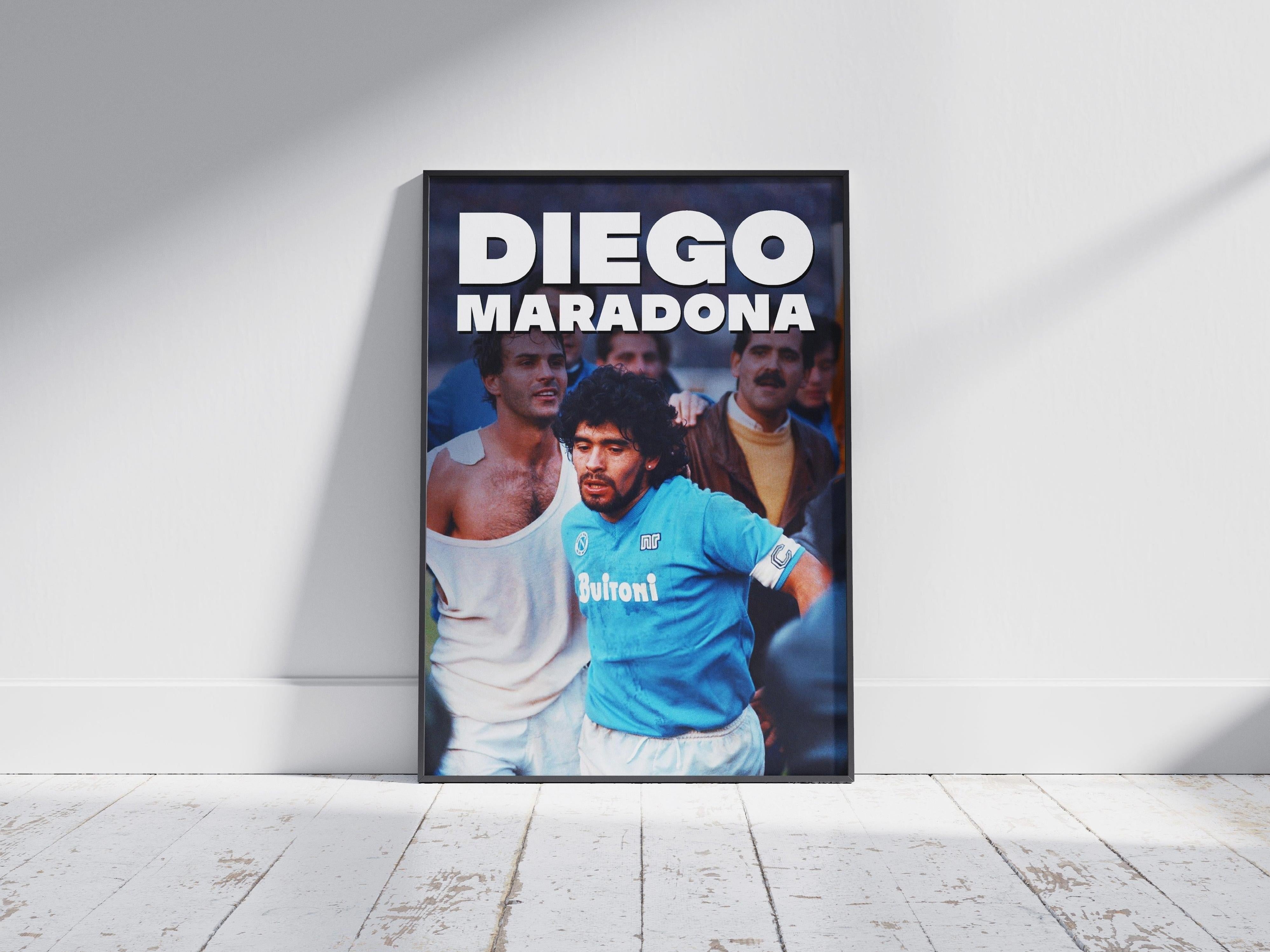 The Retro1999 Diego Maradona Napoli Poster shows Maradona in a blue jersey with “DIEGO MARADONA” at the top, framed and leaning on a white wall—a tribute to his legendary Serie A moments.