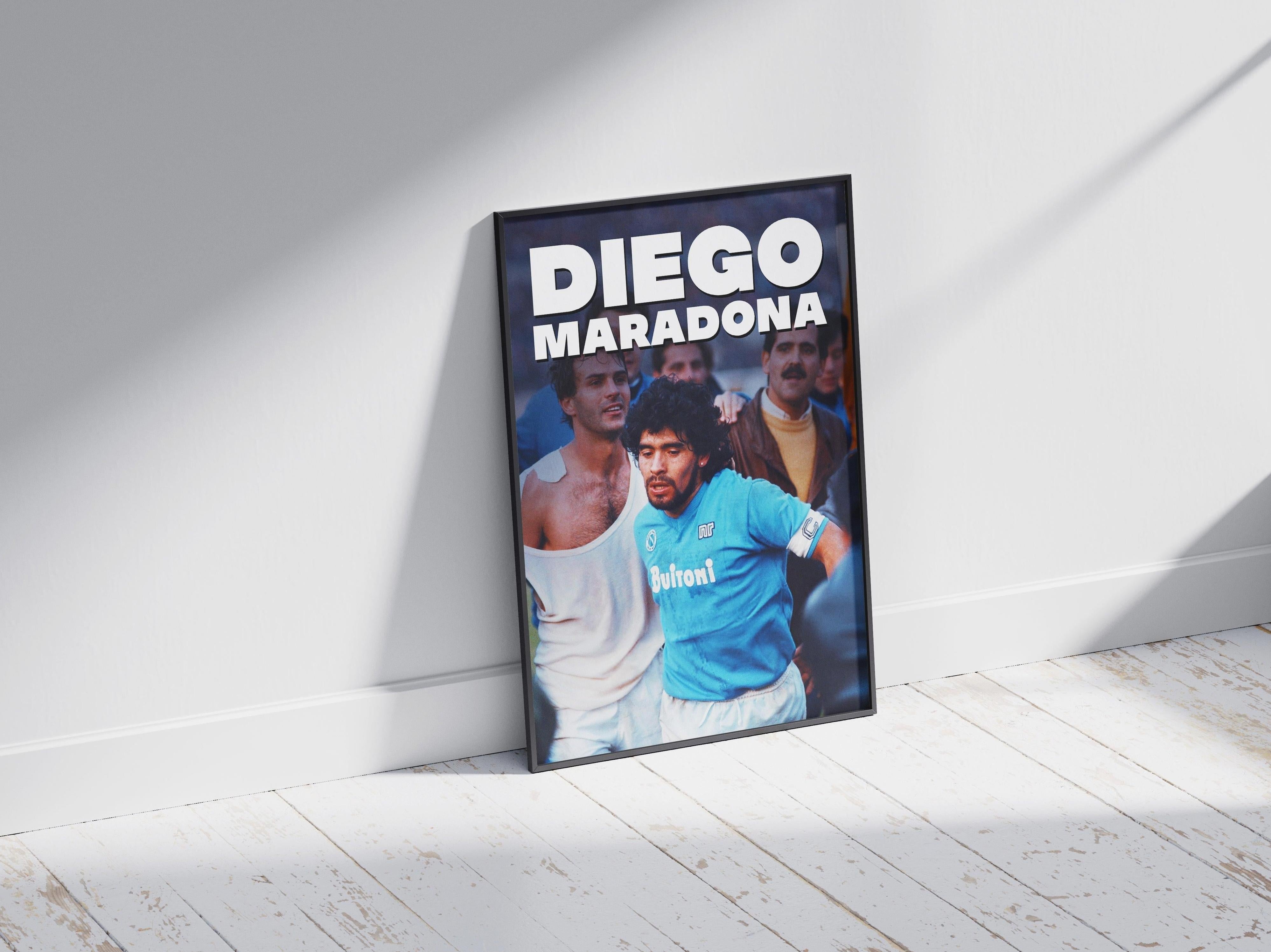 The Retro1999 Diego Maradona Napoli Poster shows Maradona in a blue jersey during a Serie A match, among other players, with DIEGO MARADONA in bold white letters at the top—an iconic tribute to football history.