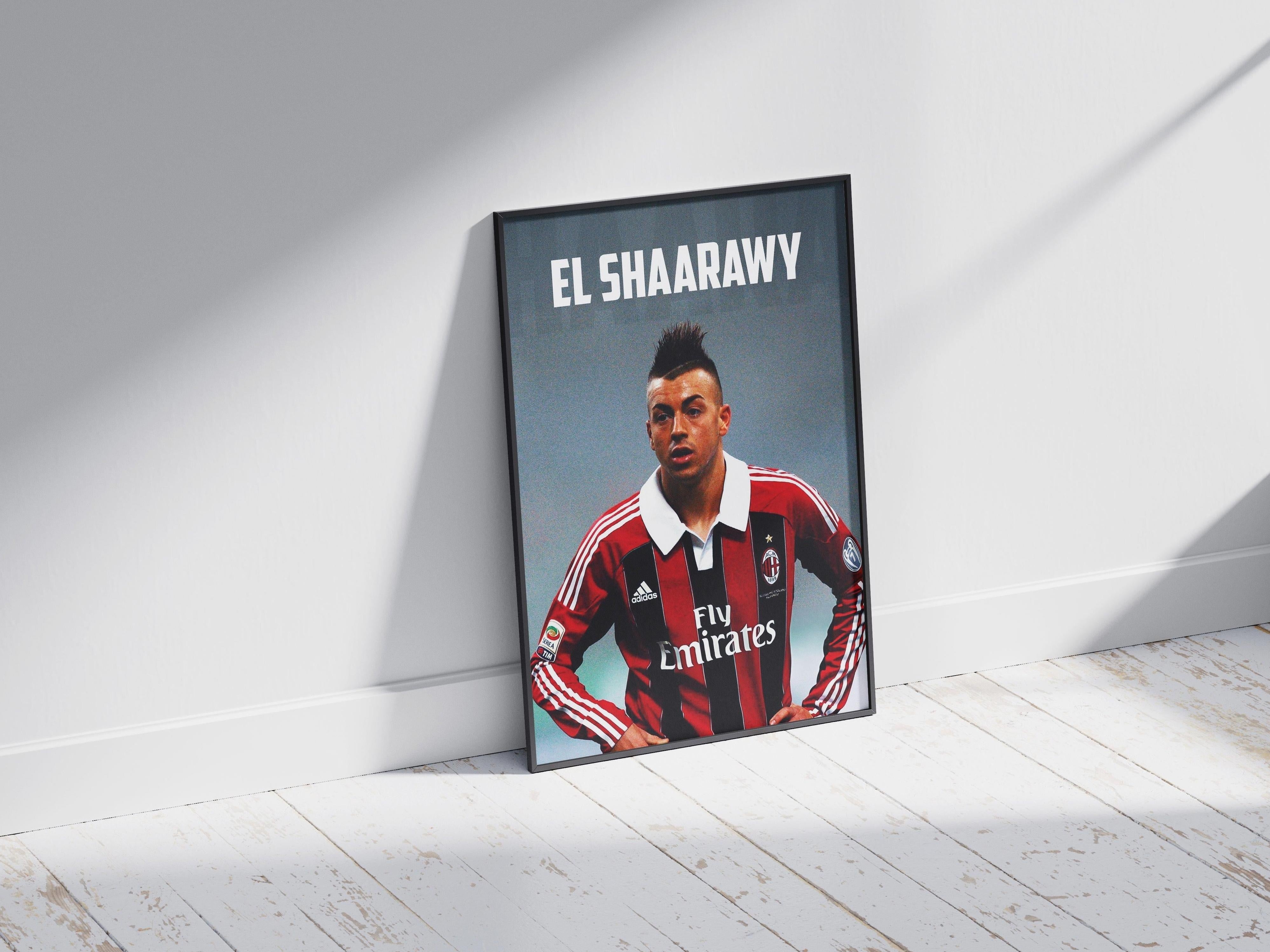 The Retro1999 El Shaarawy x AC Milan Poster, featuring Stephan El Shaarawy in an AC Milan jersey, is framed and displayed leaning against a white wall on a light wooden floor, recalling San Siro Stadium memories.
