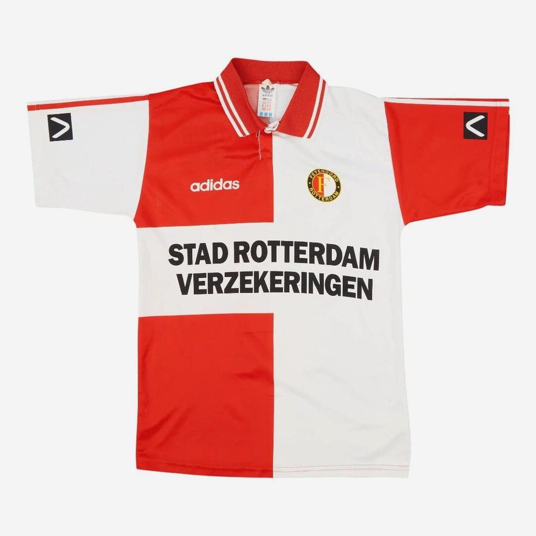 The Retro1999 Feyenoord 1994-96 Home Shirt is a red and white quartered soccer jersey with a collar, STAD ROTTERDAM VERZEKERINGEN sponsor, and club badge—a classic retro kit for Feyenoord fans.
