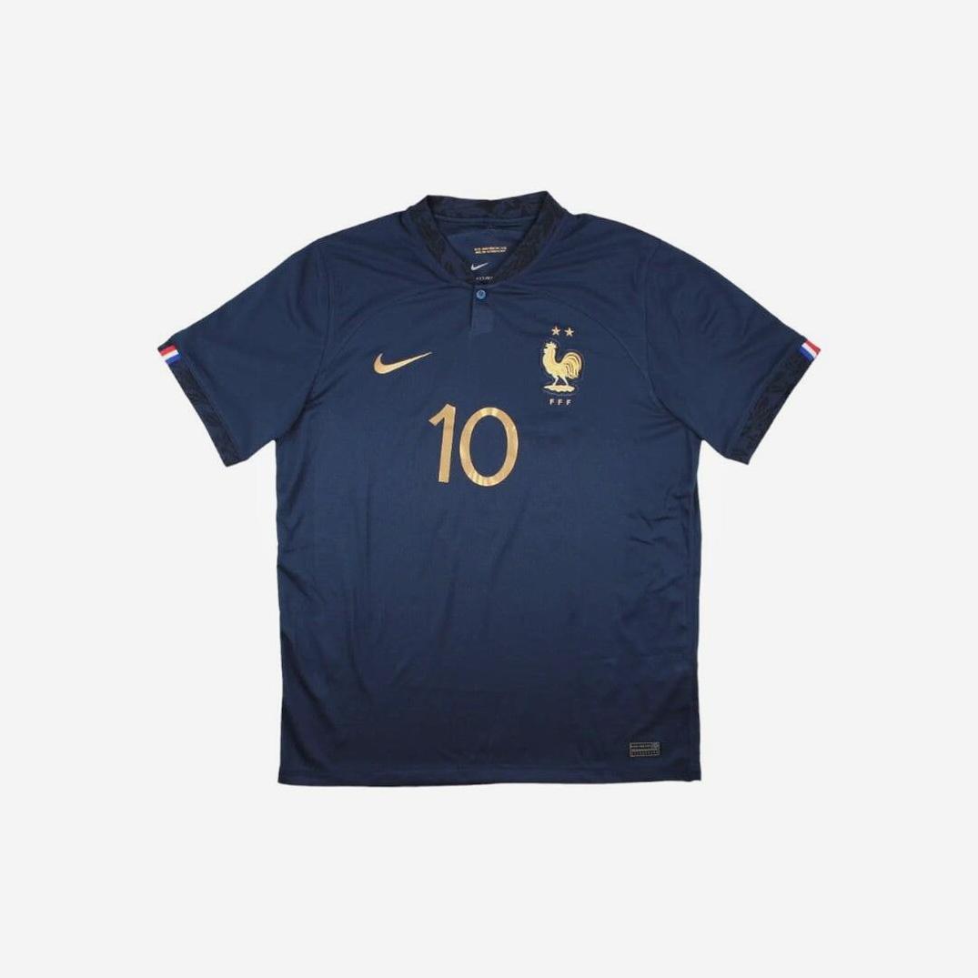 The Retro1999 France 2022 Home Shirt is dark blue with a gold number 10, crest, Nike logo, two gold stars, and small French flags on the sleeve cuffs for a retro touch.