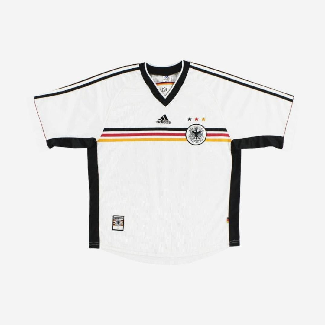 The Germany 1998 Home Shirt by Retro1999 is a white jersey featuring black, red, and yellow horizontal stripes, the Adidas logo, three stars above the crest, and retro kit details on the sleeves and sides.