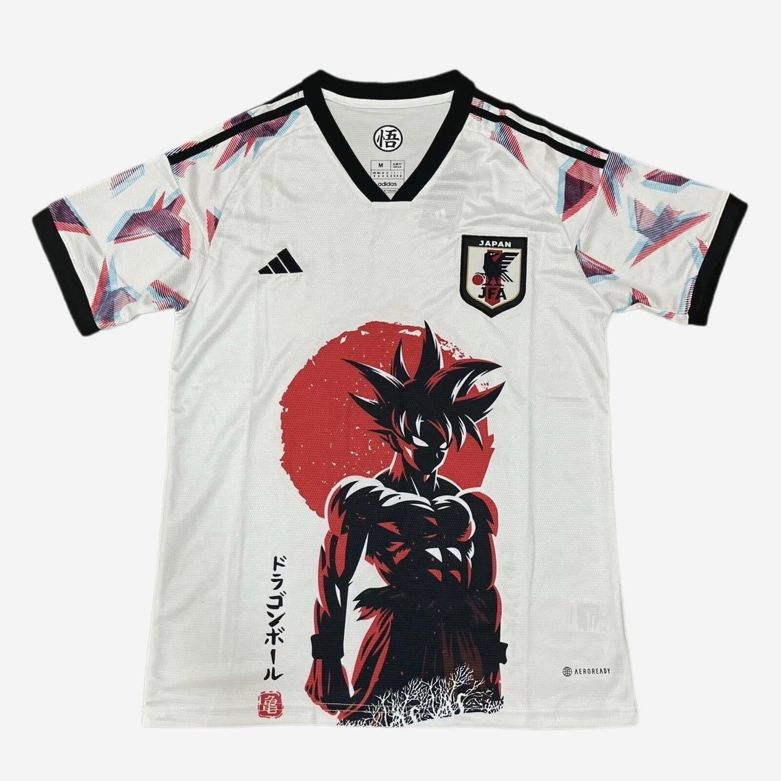The Retro1999 Japan 2024-25 Dragon Ball Goku Shirt is a white soccer jersey with black trim, Goku in front of a red sun, anime-style Japanese text, origami crane sleeve patterns, and the Japan football crest—classic retro kit style.