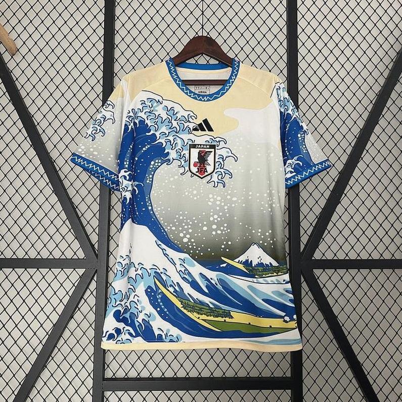 The Retro1999 Japan 2024 Sea Waves Special Edition jersey features blue waves, white foam, Mount Fuji, and a beige sky, inspired by The Great Wave off Kanagawa—a tribute to Japanese culture on national sportswear.