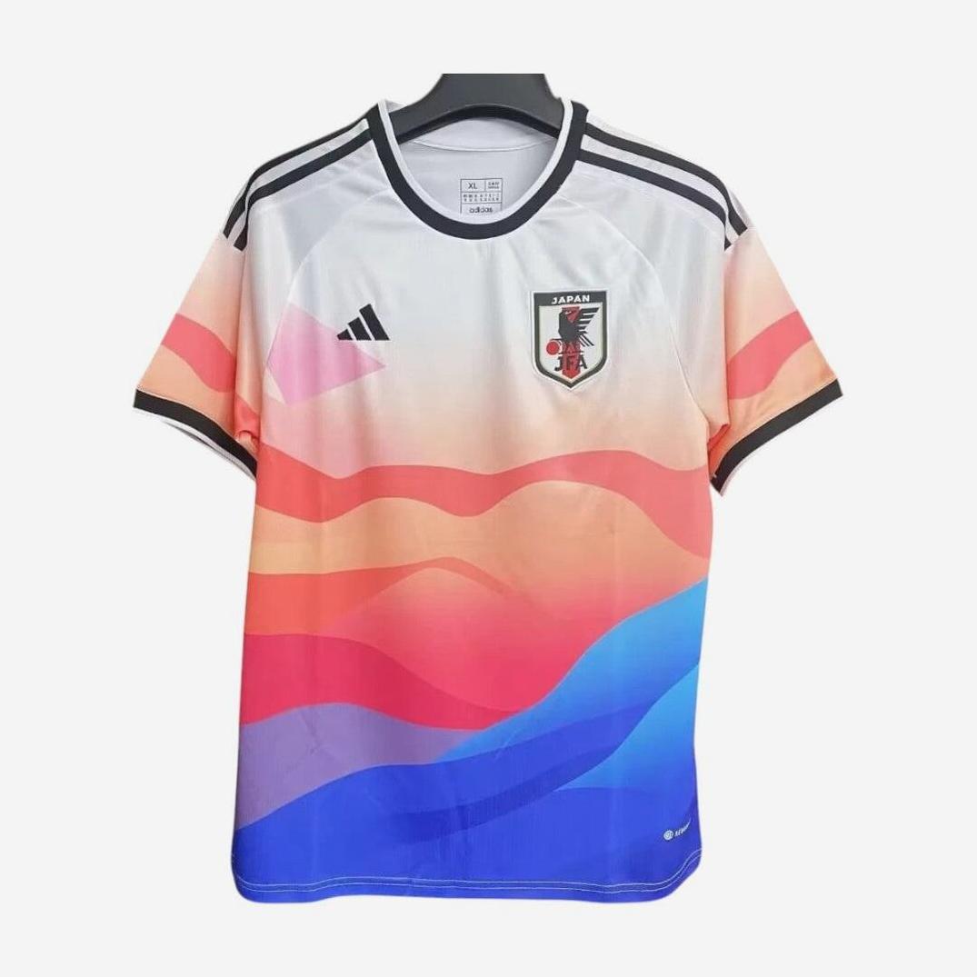 The Retro1999 Japan 2024 Special Edition jersey features a white top with colorful wavy patterns in pink, orange, red, and blue, plus the team crest and Adidas logo on the chest.