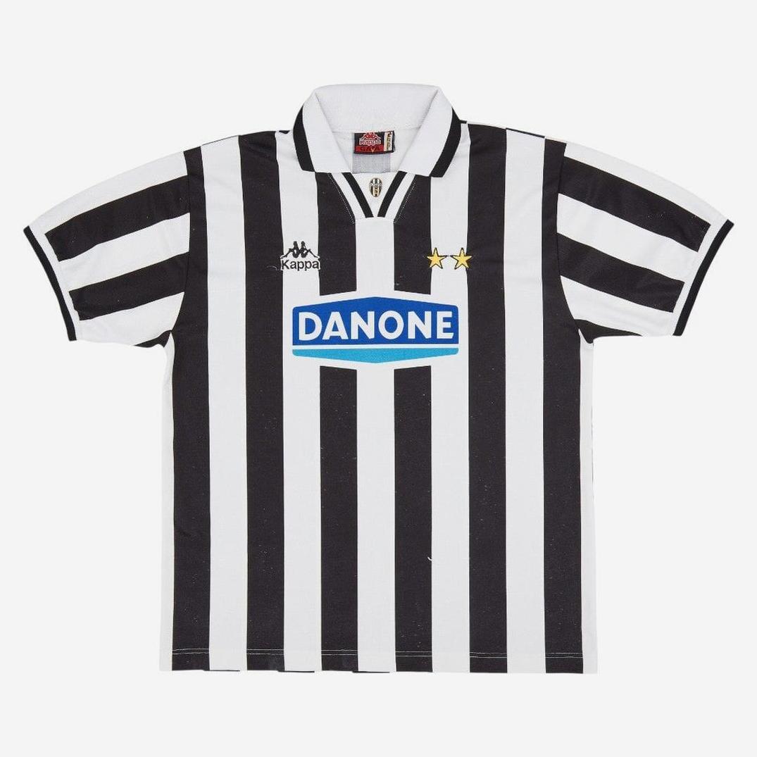 The Juventus 1994-95 Home Shirt by Retro1999 showcases classic black and white stripes, a collar, two gold stars, Kappa logos, and a blue Danone sponsor—ideal for retro football kit fans.