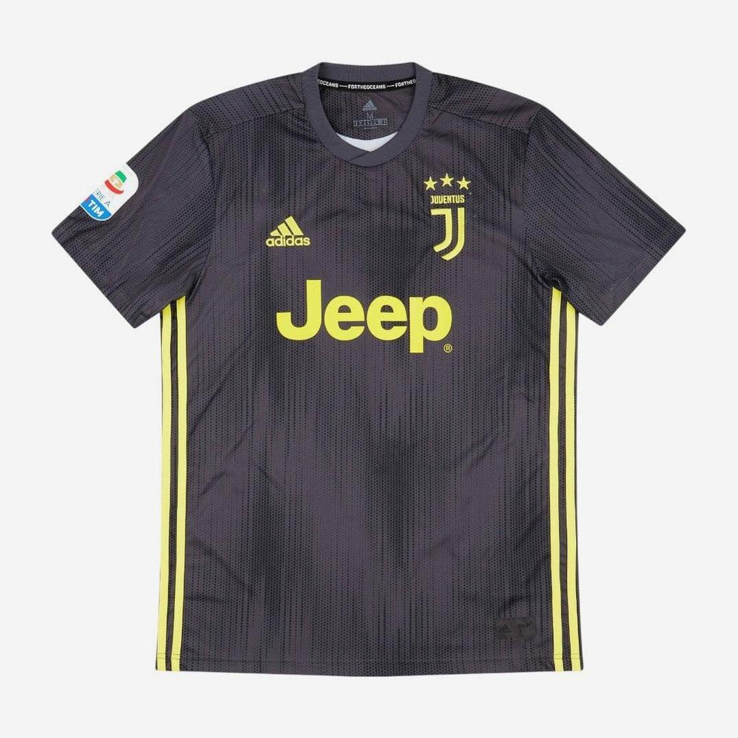 The Retro1999 Juventus 2018-19 Third Shirt features a dark gray design with yellow Adidas stripes, yellow Jeep and Adidas logos, three gold stars above the crest, and a Serie A patch on the right sleeve for a retro look.