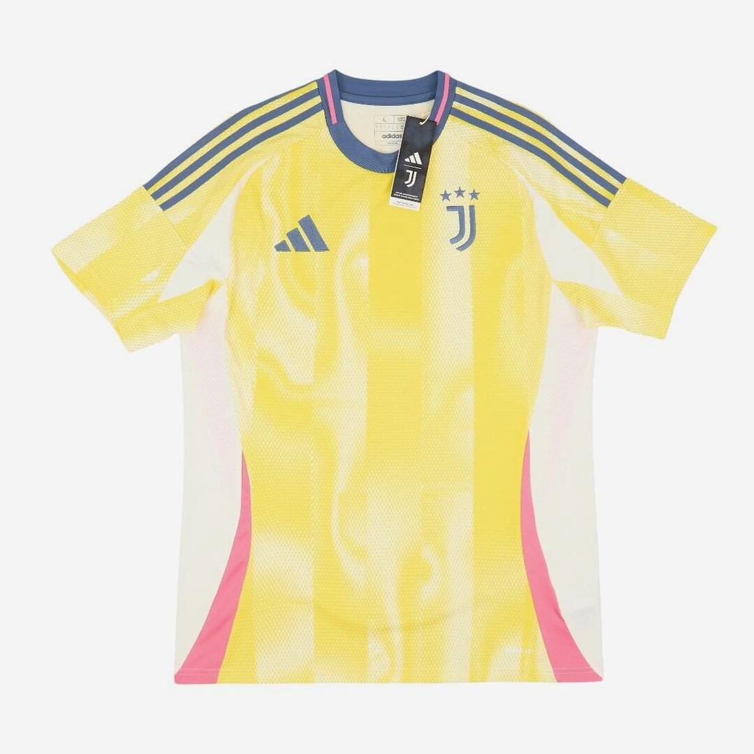 The Juventus 2024-25 Away Shirt by Retro1999 features yellow and white colors, blue Adidas shoulder stripes, a blue collar, pink side panels, and the three-star Juventus crest—ideal for Serie A fans. Tags are attached to the collar.