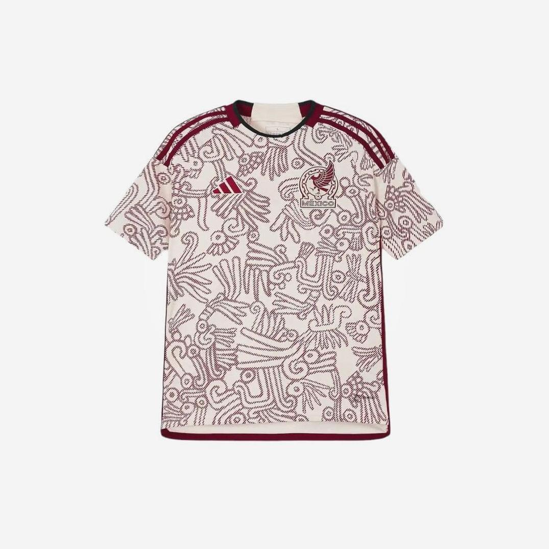 The Retro1999 Mexico 2022 Away Shirt is a beige and maroon soccer jersey with Aztec-inspired patterns, maroon shoulder stripes, and the Mexico National Team crest—ideal for fans seeking a stylish piece of team history.