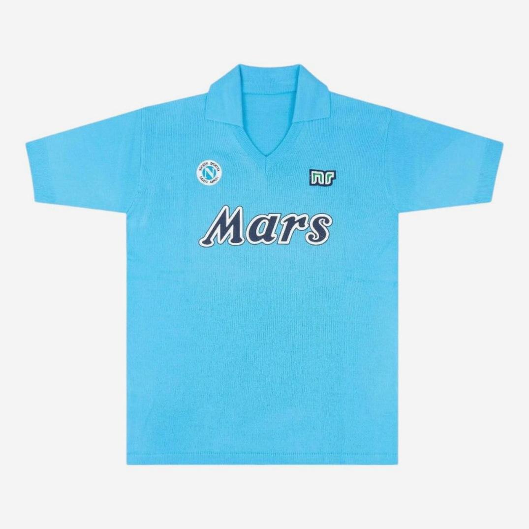 The Retro1999 Napoli 1988-89 Home Shirt is a light blue, short-sleeved soccer jersey with a collar, inspired by Maradonas era, featuring Mars across the chest and two small logos on the upper chest.