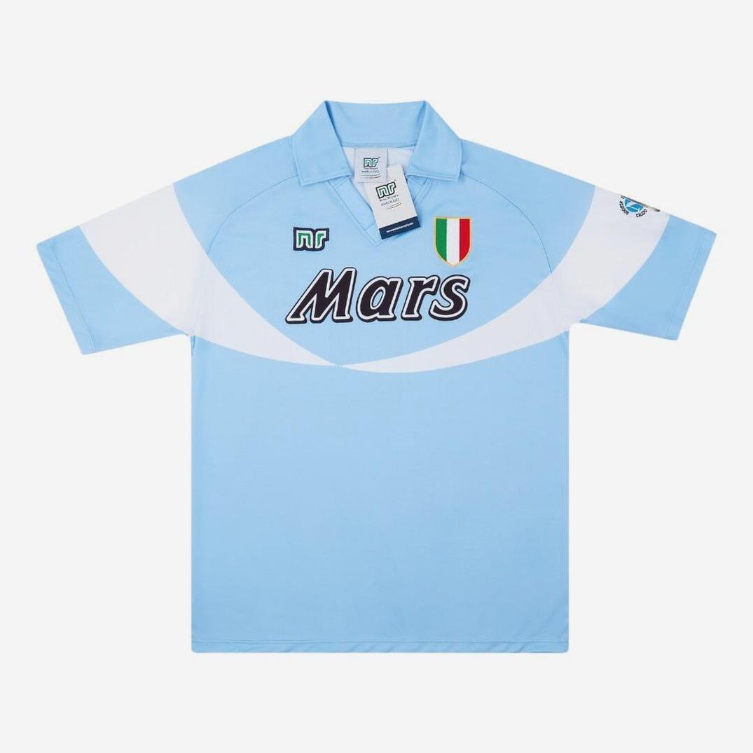 The Napoli 1990-91 Home Shirt by Retro1999 features a light blue design, white diagonal detail, black Mars sponsor logo, stitched Italian flag badge, and NR logos on the chest and sleeve. Displayed on a white background.