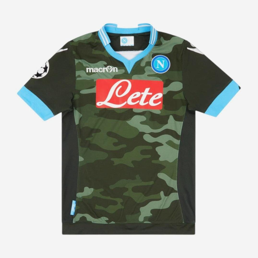 The Retro1999 Napoli 2013-14 Away Shirt features a green camouflage design, blue collar and trim, white Macron logo, red Lete sponsor, club badge on the chest, and a white sleeve patch—celebrating classic Napoli heritage.