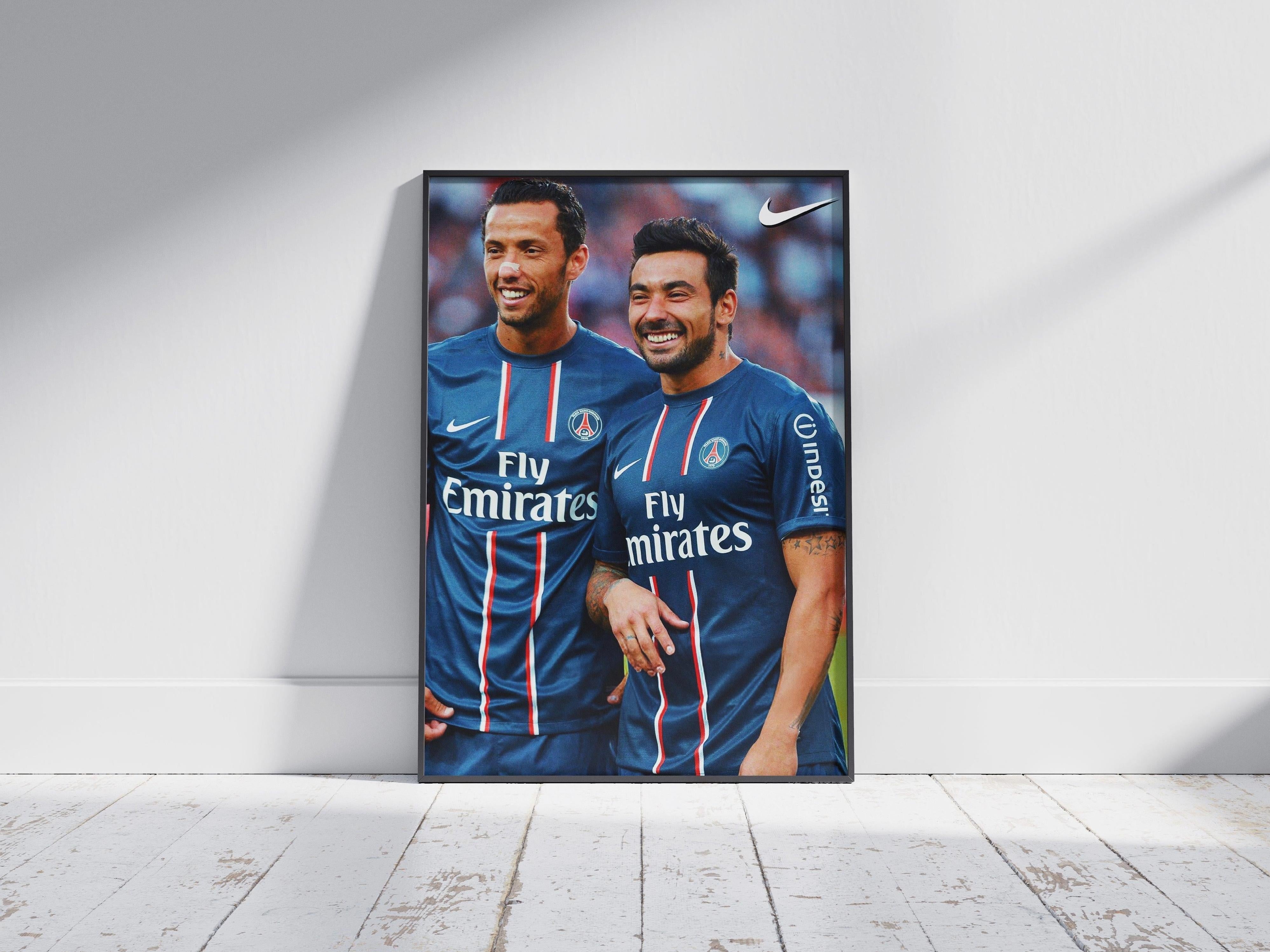The Retro1999 Nene x Lavezzi Poster features two smiling soccer stars in blue PSG jerseys, framed and leaning against a white wall—perfect memorabilia for dedicated Paris Saint-Germain fans.