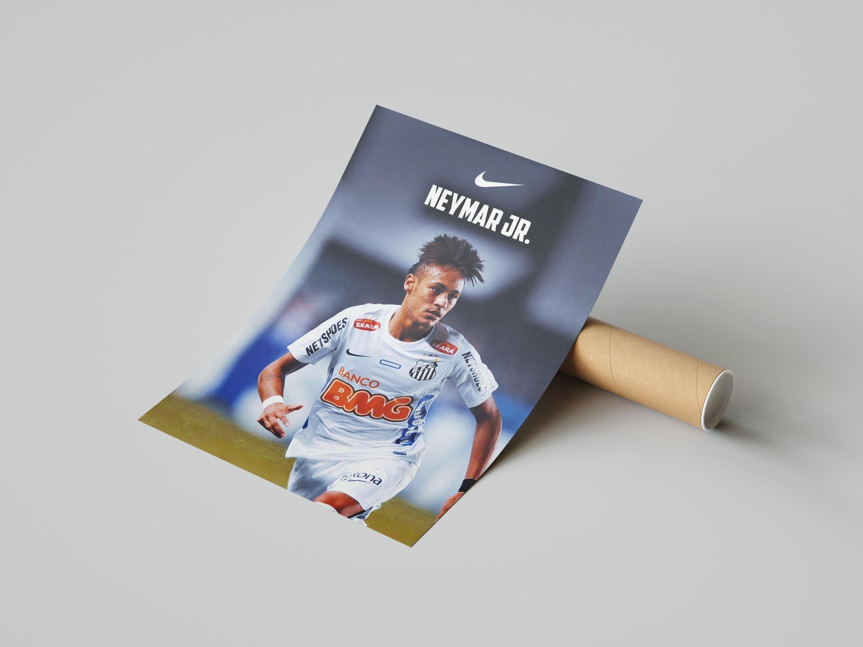 The Neymar Jr. x Santos Poster 2 by Retro1999 features the soccer legend in a white Santos FC jersey, partially unrolled with a brown cardboard tube—celebrating his iconic 2012 Copa Libertadores victory.