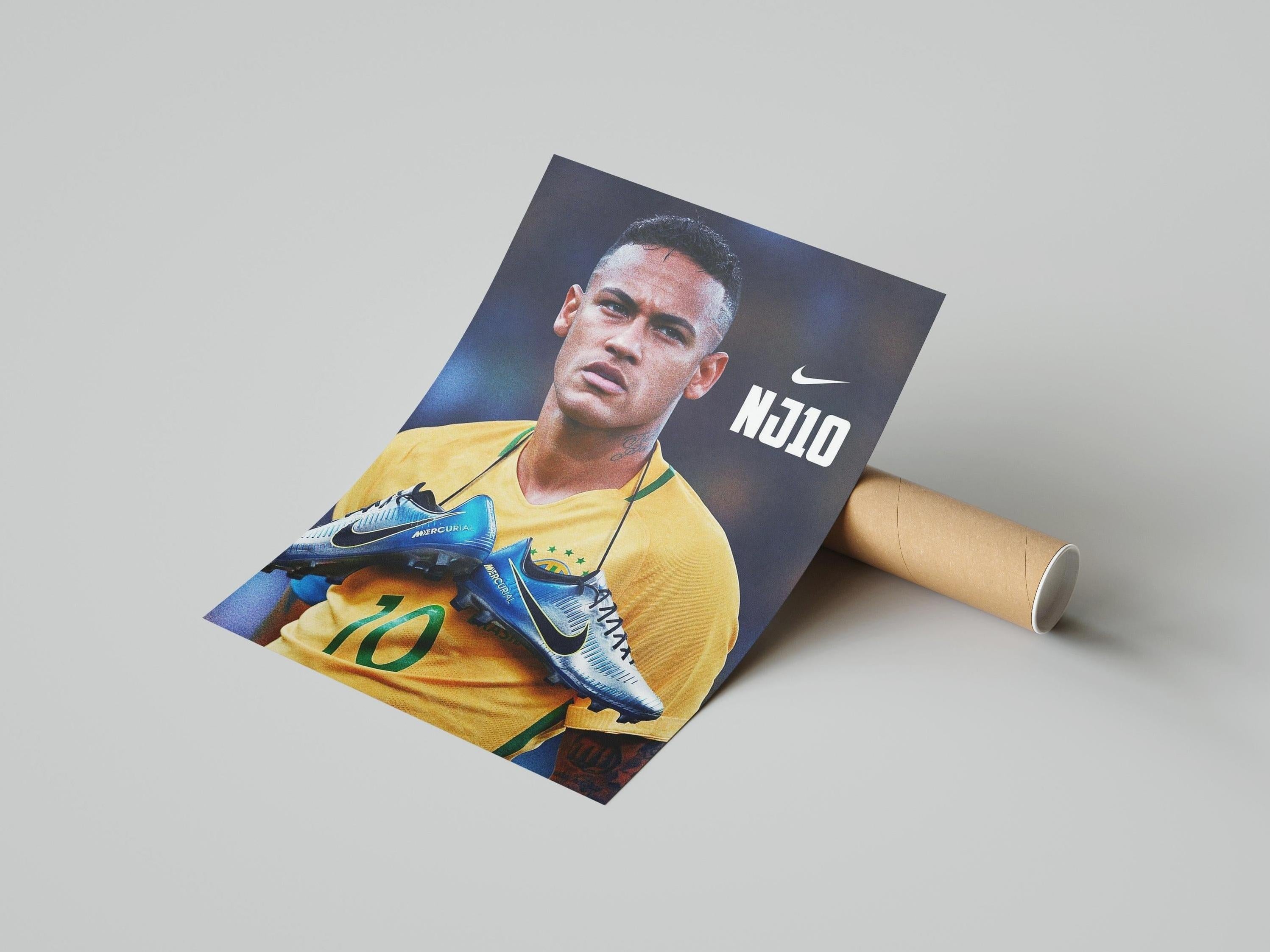 The Neymar NJ10 Poster by Retro1999 shows Neymar in a yellow jersey holding Nike Mercurial boots, with NJ10 and the Nike logo visible, placed beside a brown cardboard tube on a light gray background.