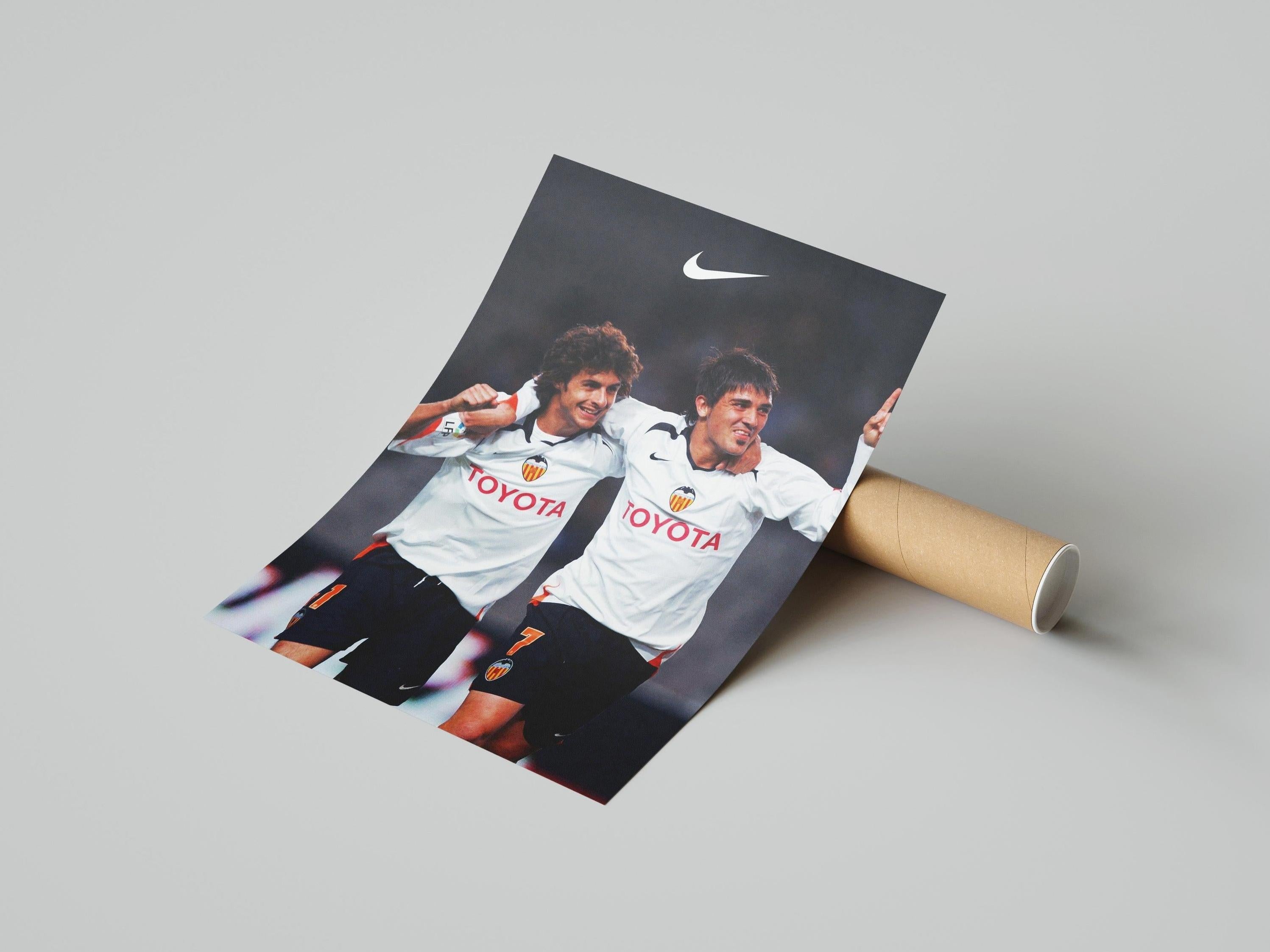 The Retro1999 Pablo Aimar x David Villa Poster shows the duo in white Valencia CF jerseys, arms around each other and smiling, with the Nike logo above—a vibrant tribute for any Spanish football fan.