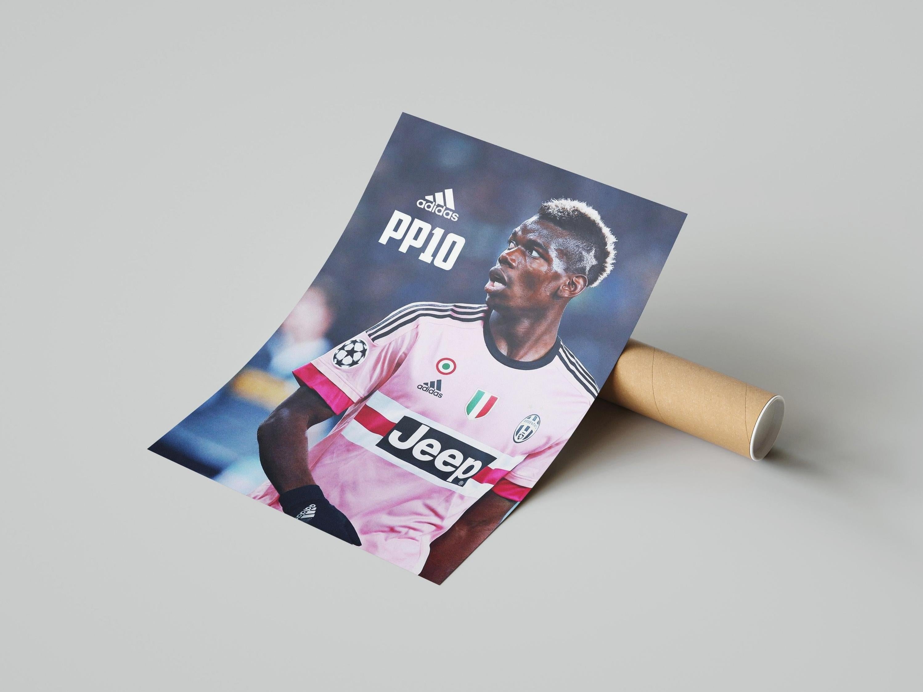 The Retro1999 Paul Pogba PP10 Poster shows the Juventus star in a pink jersey with Adidas and Jeep logos, beside a cardboard tube on a light gray background—ideal Football Fan Decor for UEFA Champions League fans.