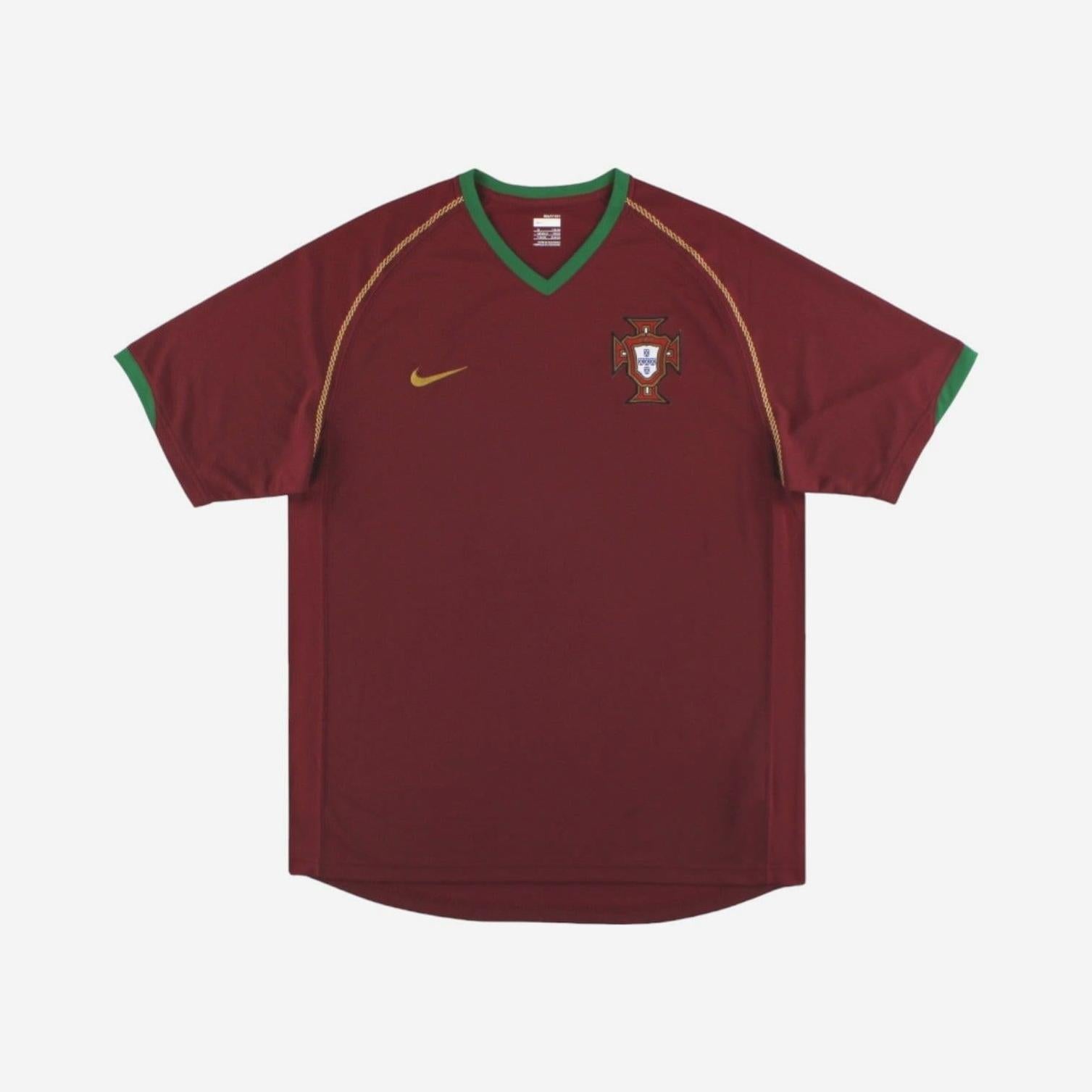 The Portugal 2006 Home Shirt by Retro1999 features maroon fabric, green trim, a gold Nike chest logo, and the Portuguese crest—an iconic retro kit for National Football Shirts fans.