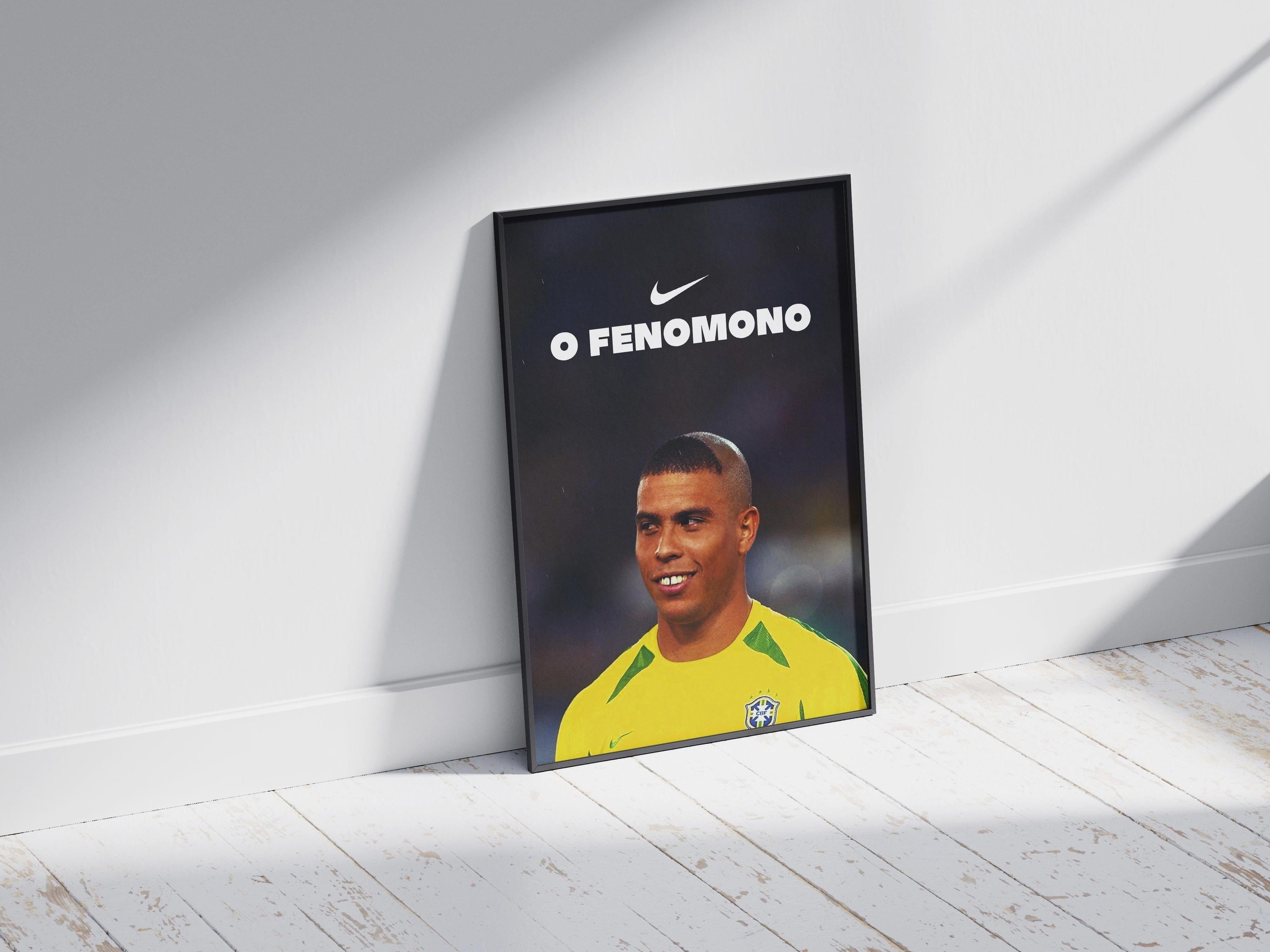 A framed Retro1999 R9 O Fenômeno Poster rests on the sunlit floor, displaying Ronaldo of Brazil in yellow with O FENOMENO and a Nike logo above him. Shadows stretch across the white wooden boards.