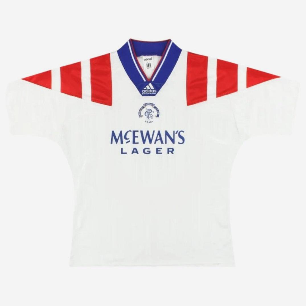 The Retro1999 Rangers F.C. 1992-94 Away Shirt is white with red shoulder stripes, blue McEwans Lager sponsor text, and the Rangers FC crest on the front. A classic kit with a blue collar and red trim—perfect football memorabilia.